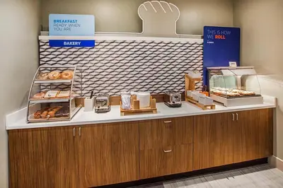 a bakery with a counter with donuts on it at Holiday Inn Express Hotel & Suites Clarington - Bowmanville by IHG in Bowmanville
