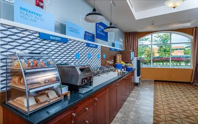 a kitchen with a counter with bread and other food at Holiday Inn Express Hotel & Suites Clarington - Bowmanville by IHG in Bowmanville