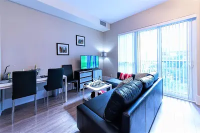 a living room with a couch and a desk at Upscale Suite at CN Tower, Metro Convention & Rogers Centre in Toronto