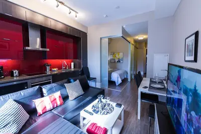 a living room with a couch and a table at Upscale Suite at CN Tower, Metro Convention & Rogers Centre in Toronto