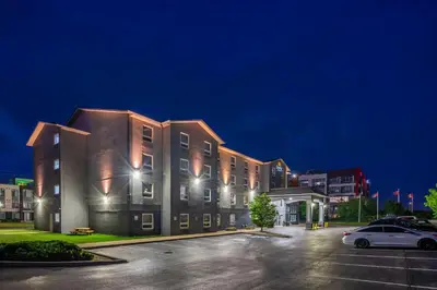 a building with cars parked in a parking lot at night at Quality Inn & Suites in Grimsby