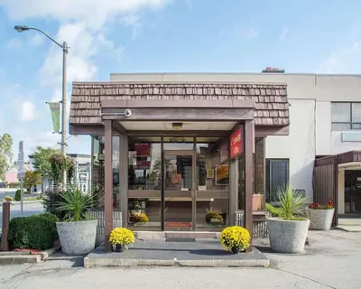 a store front with an entrance with plants in front at Econo Lodge By the Falls in Niagara Falls