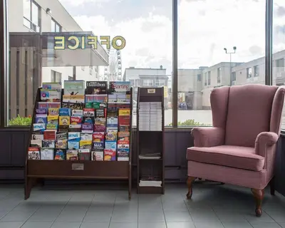 a bookstore with a chair and a display of books at Econo Lodge By the Falls in Niagara Falls