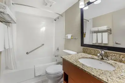 a bathroom with a sink and a toilet and a shower at Best Western Plus Rose City Suites in Welland