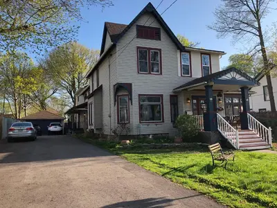 a house with a car parked in the driveway at Blue Gables Bed and Breakfast in Niagara Falls