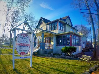 a house with a sign in front of it at Blue Gables Bed and Breakfast in Niagara Falls