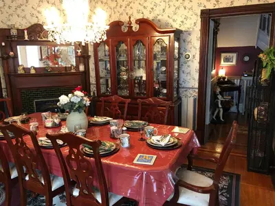 a dining room with a table with a red table cloth at Blue Gables Bed and Breakfast in Niagara Falls