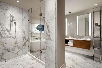 a bathroom with a shower and a sink at Park Hyatt Toronto in Toronto