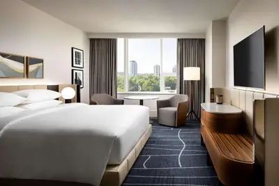 a hotel room with a large bed and a desk at Park Hyatt Toronto in Toronto