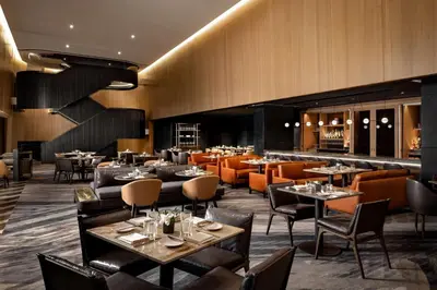 a restaurant with tables and chairs and a bar at Park Hyatt Toronto in Toronto