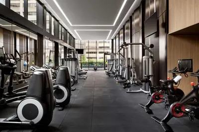 a gym with a row of treadms and machines at Park Hyatt Toronto in Toronto