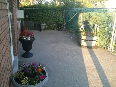 a patio with potted plants and flowers in pots at Port Motel in Port Colborne