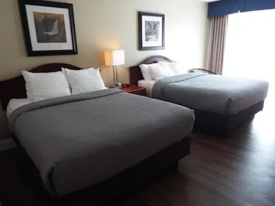 a hotel room with two beds and a lamp at Quality Inn in Owen Sound
