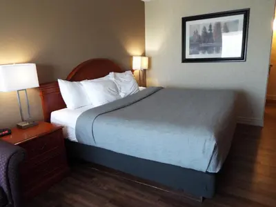 a bed in a hotel room with two lamps and a bed sidx sidx sidx sidx at Quality Inn in Owen Sound