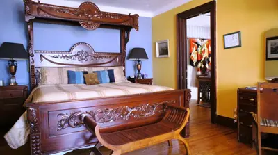 a bedroom with a wooden bed with a wooden frame at A Night to Remember B & B in Niagara Falls