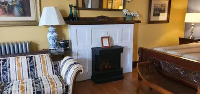 a living room with a fireplace and a couch at A Night to Remember B & B in Niagara Falls