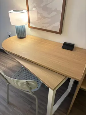 a desk in a room with a lamp and a chair at Spark by Hilton Toronto Mississauga in Mississauga