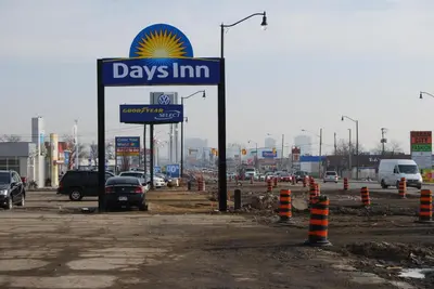 a day inn sign in a parking lot at Days Inn by Wyndham Brampton in Brampton