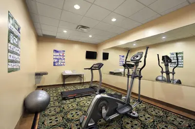 a gym with treadmills and exercise equipment in a room at Days Inn by Wyndham Brampton in Brampton