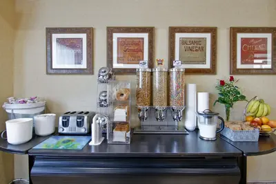 a table with a counter with food and other items on it at Travelodge by Wyndham Trenton in Trenton