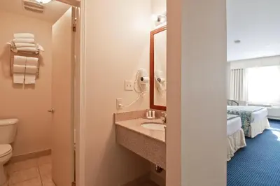 a bathroom with a sink and a toilet at Travelodge by Wyndham Trenton in Trenton