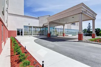 a large building with a walkway in front of it at Best Western Plus Bowmanville in Bowmanville