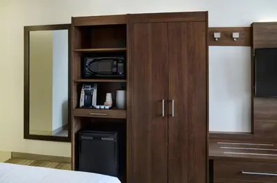 a room with a bed and a cabinet with a microwave at Holiday Inn Express Toronto Downtown by IHG in Toronto