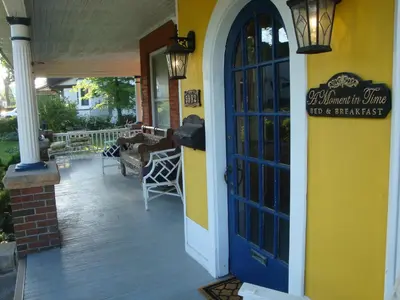 a restaurant with a blue door and a patio at A Moment in Time Bed and Breakfast in Niagara Falls