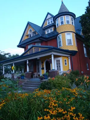 a large house with a tower on top of it at A Moment in Time Bed and Breakfast in Niagara Falls