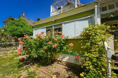 a house with flowers on the side of it at Niagara Inn Bed and Breakfast in Niagara Falls