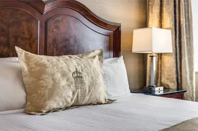 a bed with a pillow on top of it at Monte Carlo Inn & Suites Downtown Markham in Markham