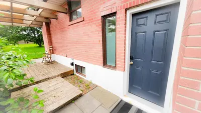 a blue door on the side of a brick house at Richview Gardens Apartment in Toronto