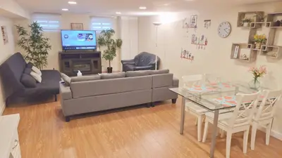 a living room with a couch and a table at Richview Gardens Apartment in Toronto