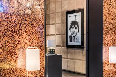 a picture of a man on a wall with two lamps at The Hazelton Hotel in Toronto