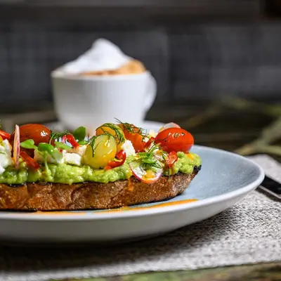 a piece of toast with vegetables on a plate at The Hazelton Hotel in Toronto