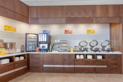 a kitchen with a counter with sinks and mirrors at GLō Best Western Mississauga Corporate Centre in Mississauga