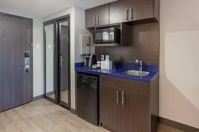 a kitchen with a sink and a counter top at GLō Best Western Mississauga Corporate Centre in Mississauga