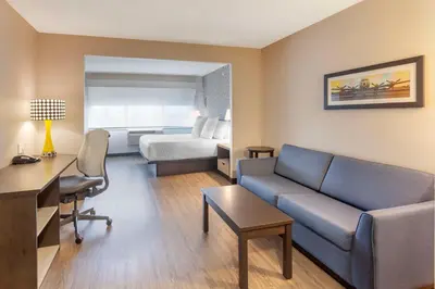 a hotel room with a couch and a bed at GLō Best Western Mississauga Corporate Centre in Mississauga