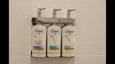 a rack with three bottles of cleaner on a wall at Holiday Inn Express Brampton by IHG in Brampton