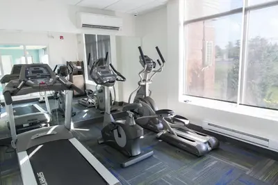 a gym with treadmills and ellipticals and a window at Holiday Inn Express Brampton by IHG in Brampton