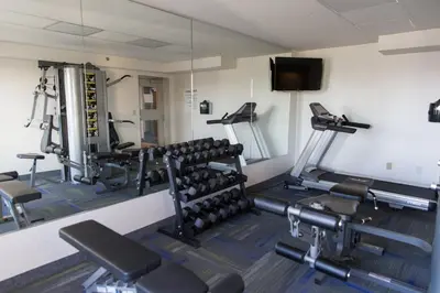 a gym with several tread machines and a tv at Holiday Inn Express Brampton by IHG in Brampton