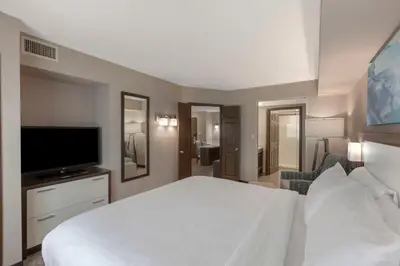 a bedroom with a white bed and a flat screen tv at Executive Residency by Best Western Toronto-Mississauga in Mississauga