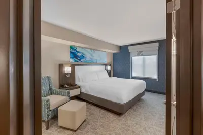 a hotel room with a bed and a chair at Executive Residency by Best Western Toronto-Mississauga in Mississauga