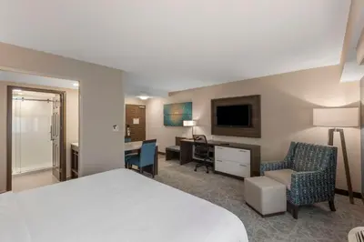 a hotel room with a bed and a desk and chair at Executive Residency by Best Western Toronto-Mississauga in Mississauga