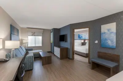 a hotel room with a bedroom with a bed and a desk at Executive Residency by Best Western Toronto-Mississauga in Mississauga