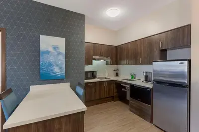a kitchen with wooden cabinets and stainless steel appliances at Executive Residency by Best Western Toronto-Mississauga in Mississauga
