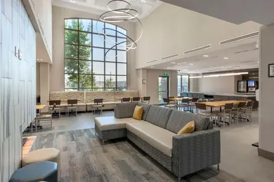 a lobby with a couch and tables and chairs at Executive Residency by Best Western Toronto-Mississauga in Mississauga