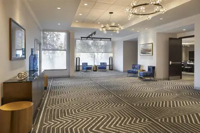 an office lobby with a carpeted floor and blue chairs at Homewood Suites by Hilton Toronto Vaughan in Vaughan