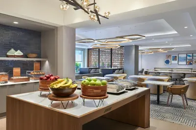 a restaurant with fruit on a counter in a hotel lobby at Homewood Suites by Hilton Toronto Vaughan in Vaughan