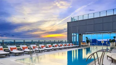 a pool with lounge chairs on the roof of a building at Hotel X Toronto, a Destination by Hyatt Hotel in Toronto